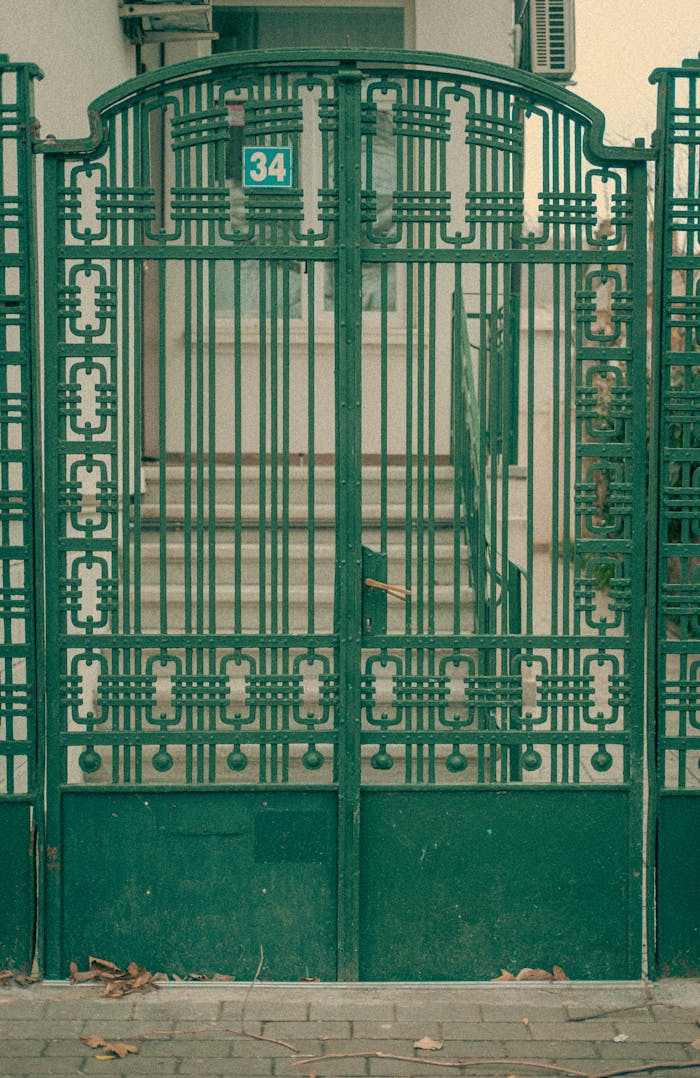 Elegant vintage green iron gate with intricate design in Varna, Bulgaria.